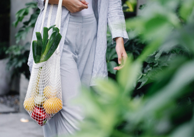 Girl carrying a bag of fruit