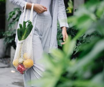 Girl carrying a bag of fruit